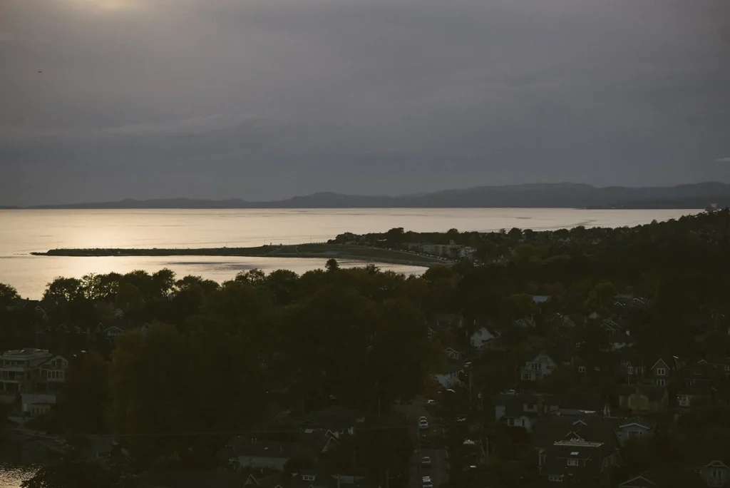 Bay at dusk with mountains on the horizon